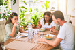 © Krakenimages.com - Beautiful family sitting on terrace eating foods speaking and smiling