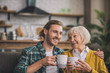 © zinkevych - Grey-haired elderly woman having morning coffee with son