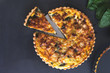 freshly bake  leek bacon spinach quiche on dark blue background with copy space, vertical,  top view