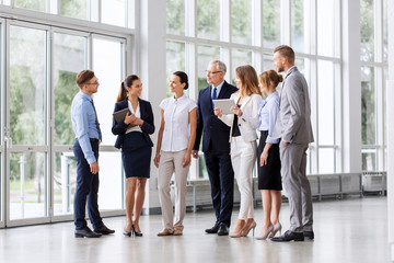 Wall Mural - people, technology and corporate concept - business team with tablet pc computers at office