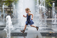 Girl Running Over Fountain