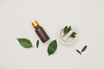 Wall Mural - spa concept with bottles of essential oil with small leaves, .salt in bowl on white background.