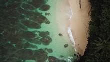 Aerial View Above People Snorkeling In The Ocean At A Tropical Beach
