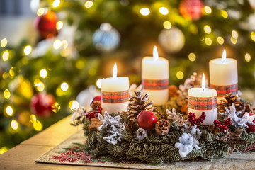 advent wreath with four white burning candles christmas ball and decorations on a wooden background 