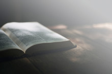 Soft Focus Open Holy Bible On Wood Table With Copy Space.