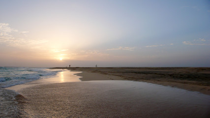 Canvas Print - person enjoying an evening walk on a secluded tropical beach in Cape Verde at sunset