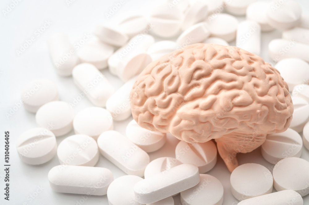 Nootropics use to improve memory and neural function, smart drugs and cognitive enhancers conceptual idea with brain and pills isolated on white background - obrazy, fototapety, plakaty 