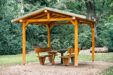 Wall Mural - Covered seating area. Gazebo, pergola in parks and gardens - relax and unwind. Wooden gazebo in the Park