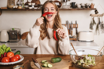 Sticker - Image of cheerful cute woman making fun with bell pepper