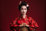 Image of beautiful young geisha woman in traditional japanese kimono