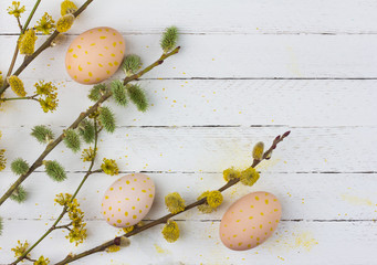 Wall Mural - spring Easter background with flowering branches of willow, dogwood and eggs on white wooden background with copy space