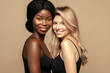 © Beauty Agent Studio - Multi Ethnic Group of Womans with diffrent types of skin  together and looking on camera. Caucasian and African ethnicity womens posing and smiling against beige background.
