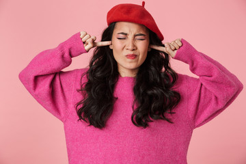 Sticker - Image of upset beautiful asian girl plugging her ears with fingers