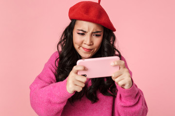 Poster - Image of young beautiful asian girl playing video games on smartphone