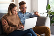 © Stock Rocket - Young couple ordering online, looking in laptop