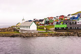 Fototapeta Na ścianę - Nolsoy island harbor with traditional Faroese church and colorful houses. Faroe Islands, Denmark.