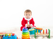 © Luis - Baby disguised as santa claus surrounded by toys