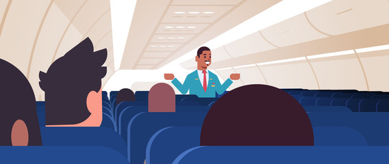 Wall Mural - steward explaining instructions for passengers african american male flight attendant in uniform showing emergency exits safety demonstration concept airplane board interior horizontal vector