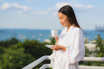 Poster - Portrait beautiful young asian women hold coffee cup in hand around outdoor view