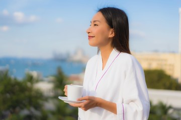 Poster - Portrait beautiful young asian women hold coffee cup in hand around outdoor view