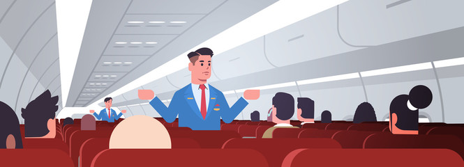 Wall Mural - steward explaining instructions for passengers male flight attendants in uniform showing emergency exits safety demonstration concept airplane board interior horizontal vector illustration