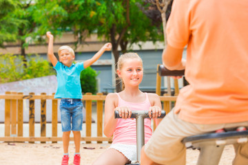 Wall Mural - Company of kids are teetering on the swing