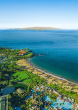 Vertical, Portrait Orientation Drone Picture Showing The Beautiful Coast Line And Beaches Of Wailea, Maui, Hawaii. Molokini Can Be Seen In The Distance. A Crescent Shaped Volcanoe Island.