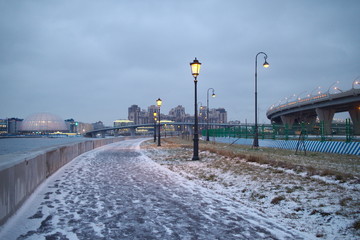 promenade with lanterns on a dark winter evening