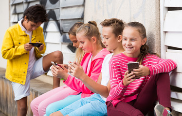 Wall Mural - Children are playing on smartphone