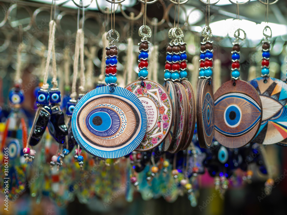 Evil eye protection amulets in a souvenir shop still life with macro effect. One of the most popular Arabic and oriental souvenirs - obrazy, fototapety, plakaty 