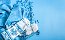 Blue Scarf And Mittens On Blue Background, Copy Space