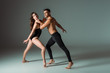 © LIGHTFIELD STUDIOS - sexy dancers dancing contemporary on dark background with copy space