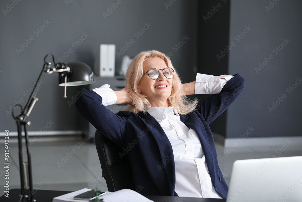 Mature businesswoman resting in office