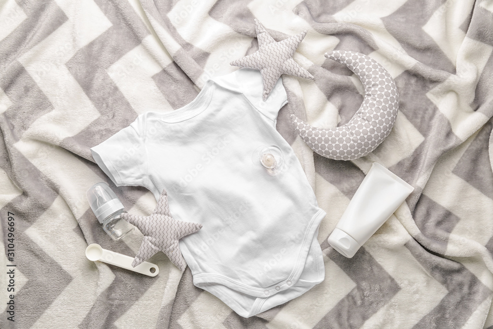 Baby clothes and accessories on plaid