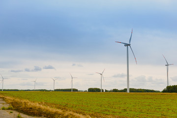 Wall Mural - Windturbine. Eco power renewable energy production from wind. Windmill saves the earth's natural ingredients. Green ecology and pure electricity