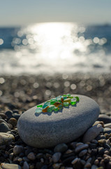 Wall Mural - glass and pebbles on the beach background