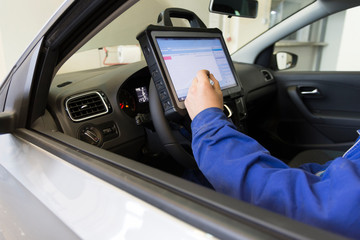 Electrical diagnostics of a car. A mechanic diagnoses a car in a car service.