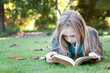Little Girl Reads Bible Outdoors
