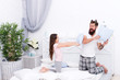 © be free - Time flies when you are having fun. Happy family have fun together. Little child and bearded man fight for fun. Pillow fight. Play games. Fun and entertainment. Family life