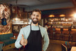 © Studio Romantic - Bearded barman waiter raised his thumb up a restaurant pub bar.