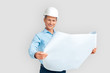 © Viktoriia - Construction. Mature man in hardhat standing isolated on white with blueprint smiling happy