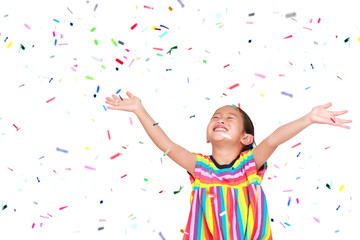 Wall Mural - Smiling little Asian kid girl with many falling colorful tiny confetti pieces on white background. Happy New Year or Congratulation Concept.