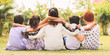 © WESTOCK - Back view, Group of kindergarten multi ethnic kids friends arm around sitting together at park outdoor - Concept showing of childhood friendship, togetherness with diversities.