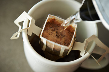 Poster - Hand drip coffee in white mug cup 