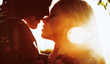 © Strelciuc - Side view portrait of a amazing young couple face to face before kissing against sunset while traveling.