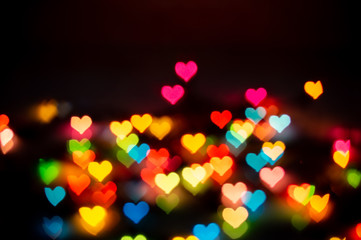 Wall Mural - colorful heart bokeh on black background