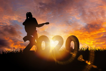 2020 New Year : Young  woman playing guitar and relaxing with music on 2020 New Year,  Happy new year concept