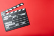 © New Africa - Clapper board on red background, top view with space for text. Cinema production