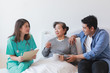 © chayathon2000 - Asian Senior old woman on the bed with doctor and her son in hospital