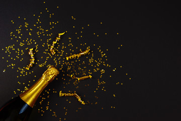 Creative concept photo of champagne bottle with star confetti